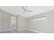 Bedroom with gray flooring, ceiling fan and access to bathroom at 35 Broadmoor Ln, Rotonda West, FL 33947