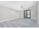 Spacious bedroom with gray vinyl plank flooring and sliding glass doors at 35 Broadmoor Ln, Rotonda West, FL 33947