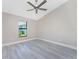 Bright bedroom with ceiling fan and grey vinyl flooring at 35 Broadmoor Ln, Rotonda West, FL 33947