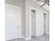 Bedroom with white closet doors and grey flooring at 35 Broadmoor Ln, Rotonda West, FL 33947