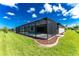 Back exterior showing house, pool, and screened enclosure at 35 Broadmoor Ln, Rotonda West, FL 33947