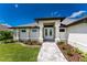 Front view of the house, showcasing its entryway and landscaping at 35 Broadmoor Ln, Rotonda West, FL 33947