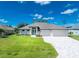 Attractive single-story home with a three-car garage and landscaped lawn at 35 Broadmoor Ln, Rotonda West, FL 33947