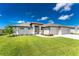 Attractive single-story home with a three-car garage and lush green lawn at 35 Broadmoor Ln, Rotonda West, FL 33947