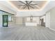 Open floor plan with kitchen island, high ceilings, and sliding doors to the pool at 35 Broadmoor Ln, Rotonda West, FL 33947