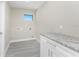 Laundry room with granite countertop and white cabinets at 35 Broadmoor Ln, Rotonda West, FL 33947