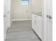 Laundry room with white cabinets, granite countertop and grey vinyl flooring at 35 Broadmoor Ln, Rotonda West, FL 33947