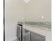 Close-up of outdoor kitchen area with wine fridge, beverage cooler, and granite counter at 35 Broadmoor Ln, Rotonda West, FL 33947