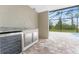 Covered patio with built-in grill, wine cooler, and screened enclosure overlooking a pool at 35 Broadmoor Ln, Rotonda West, FL 33947