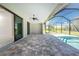 Screened-in patio with a pool, ceiling fan, and sliding glass doors at 35 Broadmoor Ln, Rotonda West, FL 33947