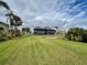 Large home with a screened lanai and lush lawn at 5177 The Pointe, Englewood, FL 34223