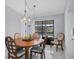 Dining room with wooden table and chairs, near sliding doors at 5194 Cooper Ter, Port Charlotte, FL 33981