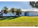 Charming single-story home with a light blue exterior and lush lawn at 5194 Cooper Ter, Port Charlotte, FL 33981