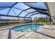 Enclosed kidney-shaped pool with canal views at 5194 Cooper Ter, Port Charlotte, FL 33981