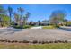 Front view of house showcasing landscaping and curved driveway at 540 Green Dolphin S Dr, Placida, FL 33946