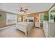 Main bedroom with a king-size bed, ceiling fan, and plenty of natural light at 55 Bamboo Dr, Port Charlotte, FL 33954