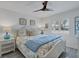 Bedroom with queen bed, coastal decor, and ceiling fan at 5856 Gasparilla Rd # M27, Boca Grande, FL 33921