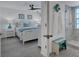 Guest bedroom with queen bed and adjacent bathroom at 5856 Gasparilla Rd # M27, Boca Grande, FL 33921