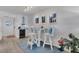 Bright breakfast nook with white table and chairs, built-in cabinetry, and wine cooler at 5856 Gasparilla Rd # M27, Boca Grande, FL 33921