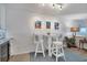 Coastal-themed breakfast nook with white table and chairs at 5856 Gasparilla Rd # M27, Boca Grande, FL 33921