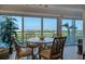 Casual dining area with water views, ideal for small gatherings at 5856 Gasparilla Rd # M27, Boca Grande, FL 33921