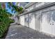 White garages with gravel driveway at 5856 Gasparilla Rd # M27, Boca Grande, FL 33921