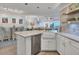 Modern white kitchen with farmhouse sink and stainless steel appliances at 5856 Gasparilla Rd # M27, Boca Grande, FL 33921