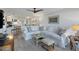 Open concept living room and kitchen with white furniture at 5856 Gasparilla Rd # M27, Boca Grande, FL 33921