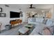 Open concept living area with white sectional sofa and hardwood floors at 5856 Gasparilla Rd # M27, Boca Grande, FL 33921