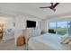 Spacious main bedroom with king bed, dresser, and balcony access at 5856 Gasparilla Rd # M27, Boca Grande, FL 33921