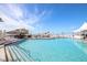 Resort-style pool with a tiki bar and ample seating at 5856 Gasparilla Rd # M27, Boca Grande, FL 33921