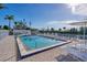 Community pool with lounge chairs and waterfront access at 5856 Gasparilla Rd # M27, Boca Grande, FL 33921