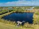 Property features a private pond with a dock, offering serene views at 6341 Biggs St, Englewood, FL 34224