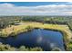 Expansive property with a pond, dock, and surrounding nature at 6341 Biggs St, Englewood, FL 34224
