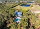 Aerial view of home with pool, surrounded by tropical landscaping at 6341 Biggs St, Englewood, FL 34224