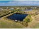 Overlooking a private pond with a dock and lush landscape at 6341 Biggs St, Englewood, FL 34224