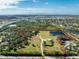 Aerial view of a large property with multiple buildings and a pond at 6341 Biggs St, Englewood, FL 34224