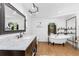 Elegant bathroom featuring a claw-foot tub, updated fixtures, and marble vanity top at 6341 Biggs St, Englewood, FL 34224