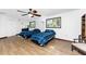 Bright bedroom with two beds, wood-look floors, large windows and a ceiling fan at 6341 Biggs St, Englewood, FL 34224