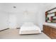 Cozy bedroom featuring a bed, ceiling fan, dresser, and built-in shelves at 6341 Biggs St, Englewood, FL 34224