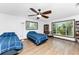 Bedroom with two twin beds, large windows, and built in bookcases at 6341 Biggs St, Englewood, FL 34224