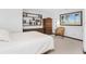 Bright bedroom with a comfortable bed, built-in shelving, and a window with a view at 6341 Biggs St, Englewood, FL 34224