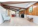 Bright and spacious common area with wood paneling and tile flooring at 6341 Biggs St, Englewood, FL 34224
