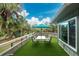 Spacious deck with a table, chairs, and artificial turf at 6341 Biggs St, Englewood, FL 34224