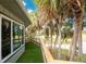 Private deck with artificial turf, wooden railing, and lush tropical landscaping at 6341 Biggs St, Englewood, FL 34224