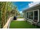 Outdoor deck space featuring a dining area, grill, and artificial turf at 6341 Biggs St, Englewood, FL 34224