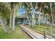 Two story home with a walkway leading to the entrance, surrounded by lush landscaping at 6341 Biggs St, Englewood, FL 34224
