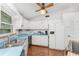 Bright kitchen features white cabinets, light blue countertops, and stainless steel appliances at 6341 Biggs St, Englewood, FL 34224