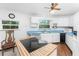 Efficient kitchen with white cabinets, blue countertops, and stainless steel appliances at 6341 Biggs St, Englewood, FL 34224
