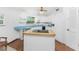 Bright kitchen with white cabinets, blue countertops and an island at 6341 Biggs St, Englewood, FL 34224